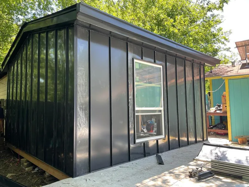 Black standing seam metal wall panels for Roof Inspection in Harvey