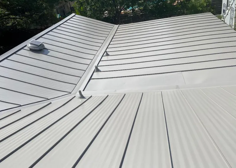 Solar attic fan installed on a metal roof for Roof Ventilation in Harvey